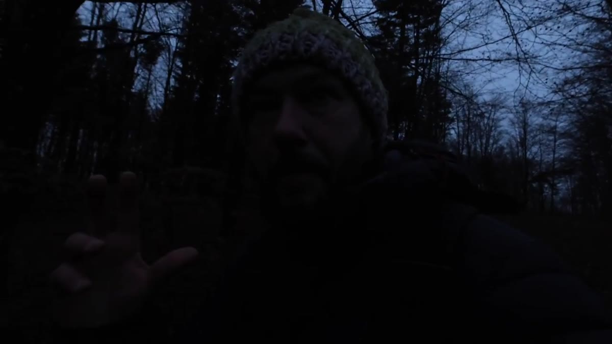 Nigel and companion entering a narrow woodland opening