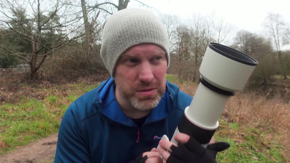 Canon RF 100-500mm lens shown in Adam&rsquo;s hands outdoors