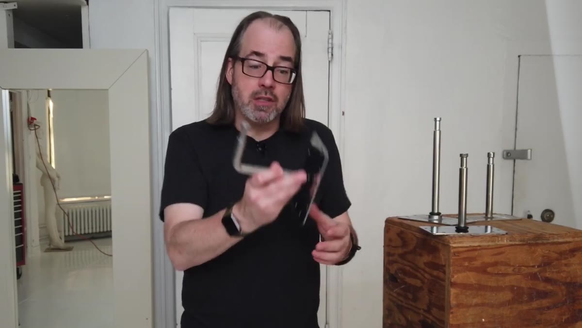 Demonstration of right-angle baby plates mounted on a wall with bar across them