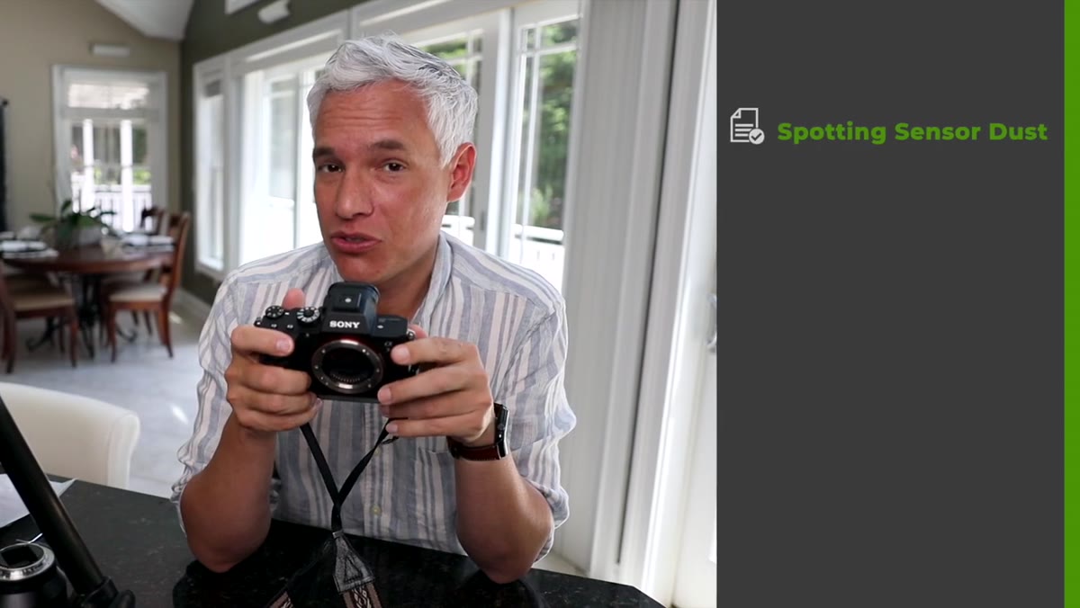 Camera pointed at white wall showing sensor dust spots