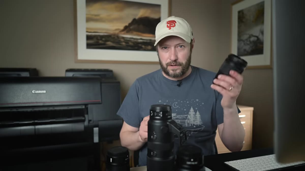 Danson comparing the 24-200mm zoom to the f/2.8 prime zooms in hand