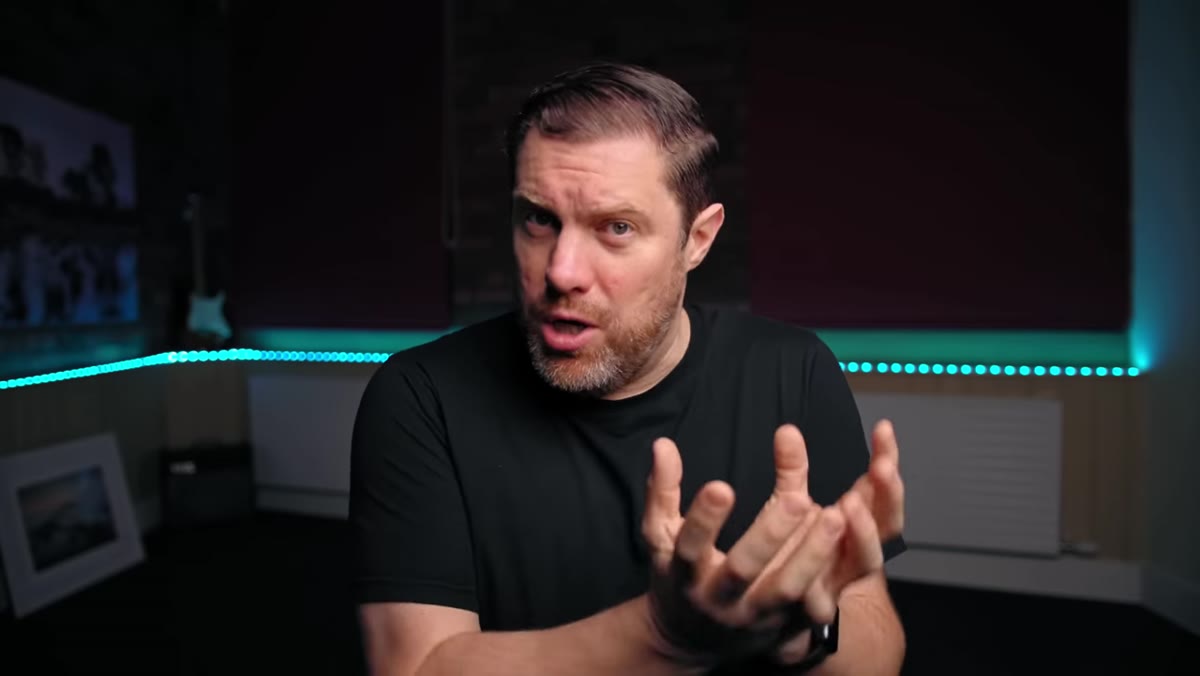 caption: Presenter describing how a new lens expands focal range options