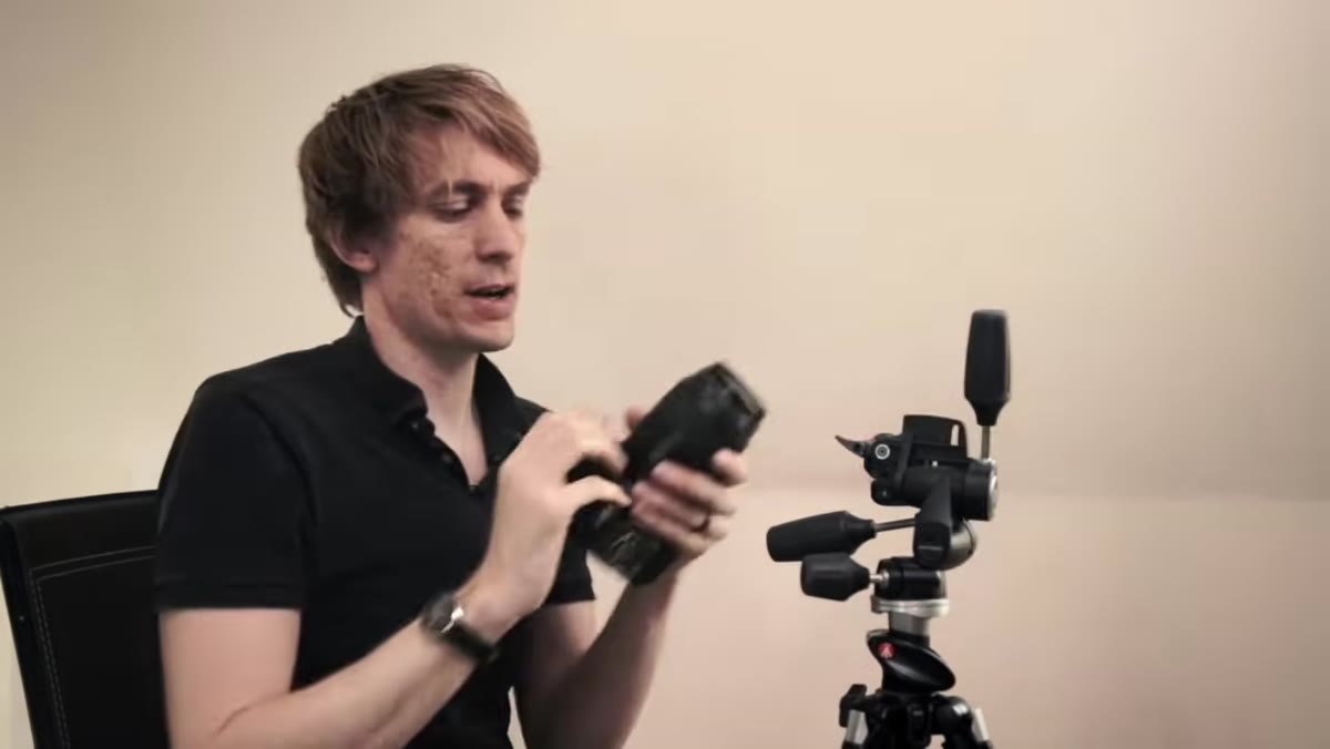 Tucker holding Canon 5D Mark II with 100mm macro lens attached