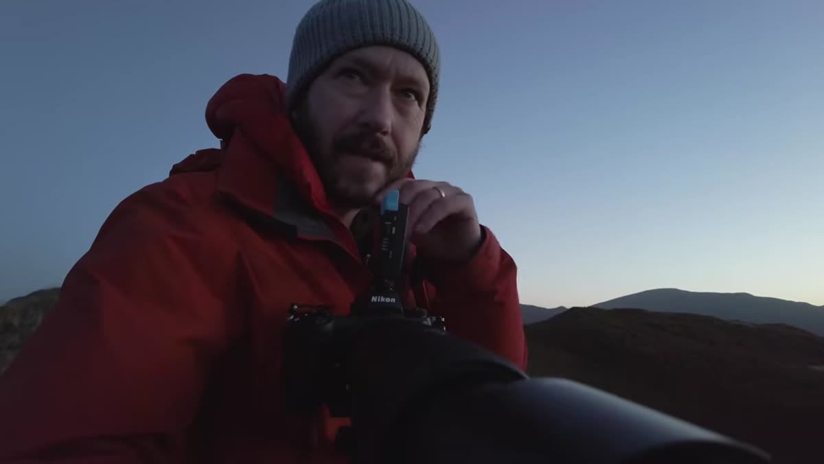 Danson reviewing composition and checking frame edges on camera screen