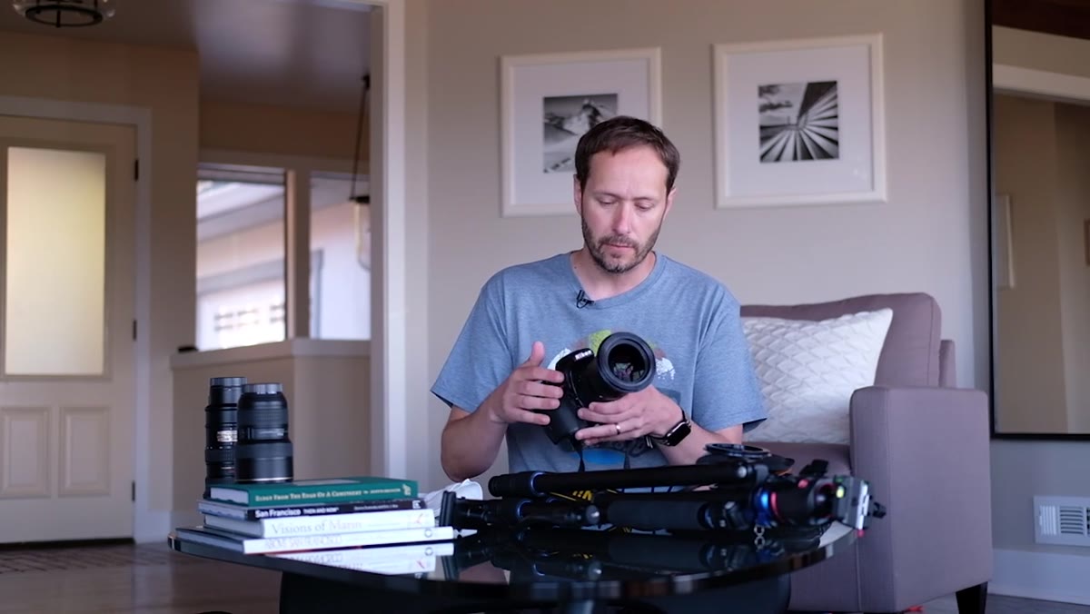 Nikon D810 with 24-70mm lens attached, held up to camera