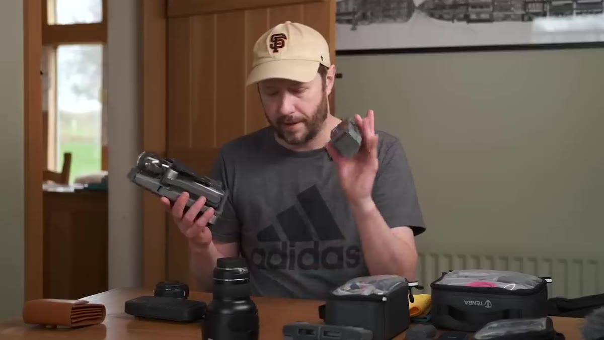 DJI Mavic 2 Pro with controller and spare battery being placed in front pocket