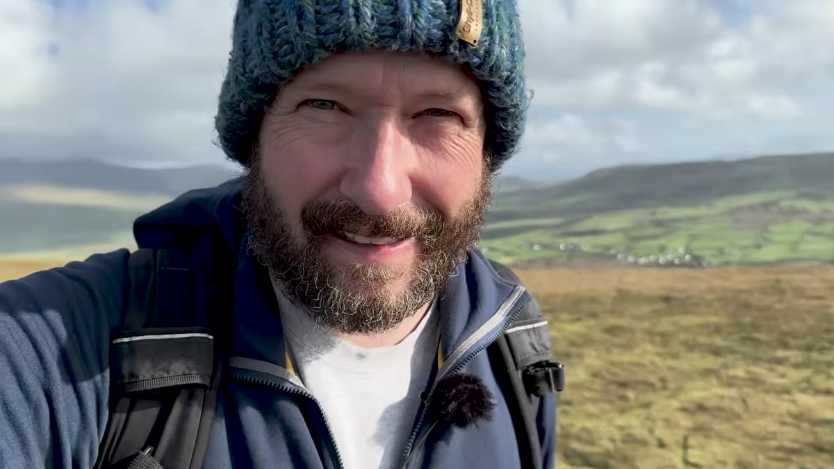 Nigel scanning cliffs with phone before raising camera