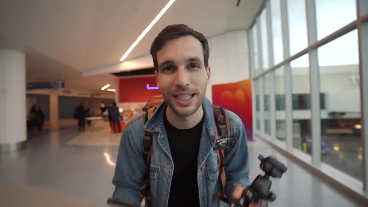 Photographer showing packed carry-on bag filled with camera gear