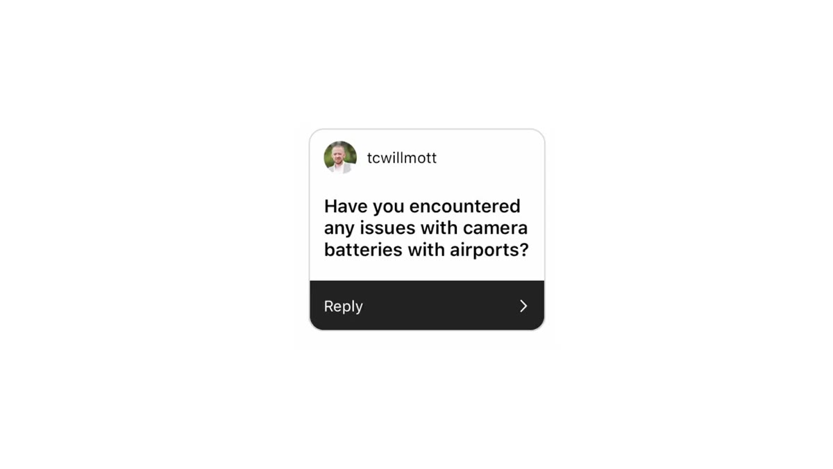 Spare camera batteries visible inside carry-on backpack
