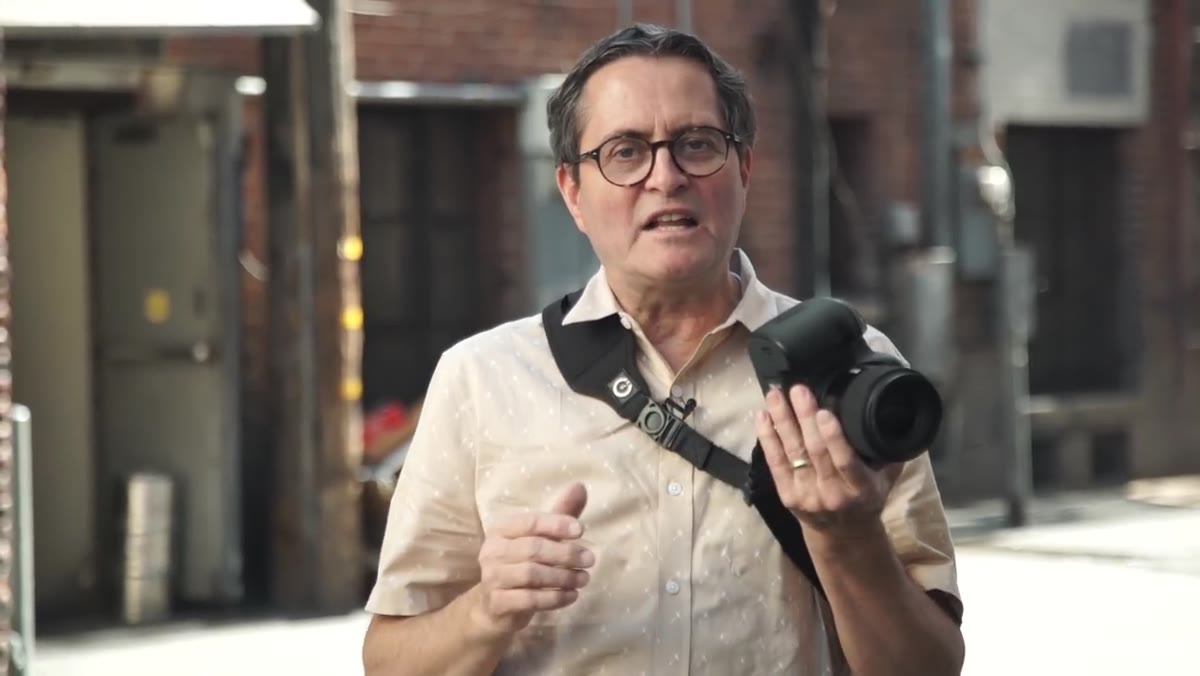 Jay removing lens hood from camera before shooting