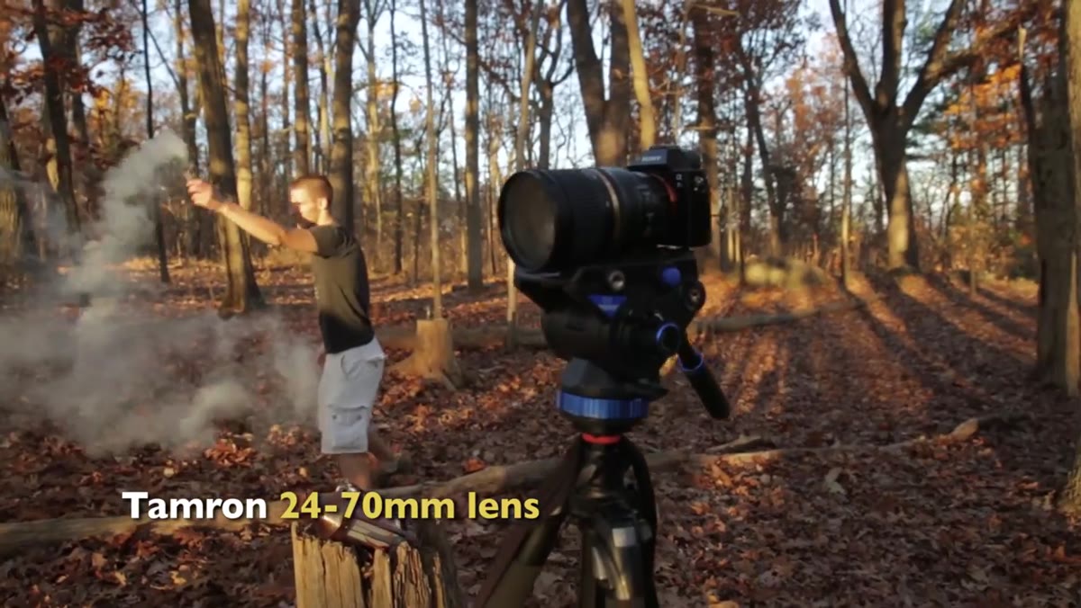 Smoke grenade being used in background trees behind Lincoln