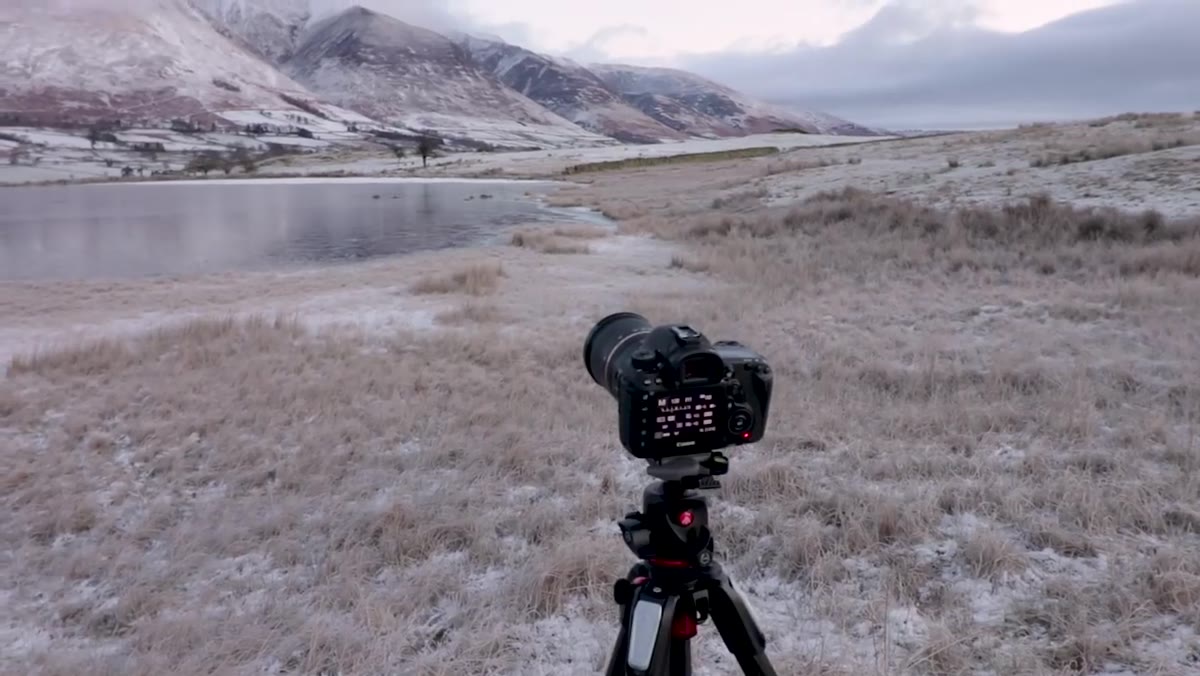 Camera mounted on tripod, tripod legs extended fully, level scene