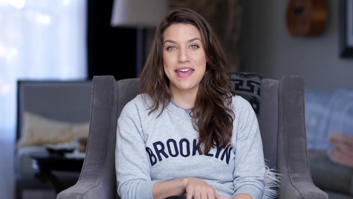 Chelsea applying concealer to minimize visible eyebrows and lashes