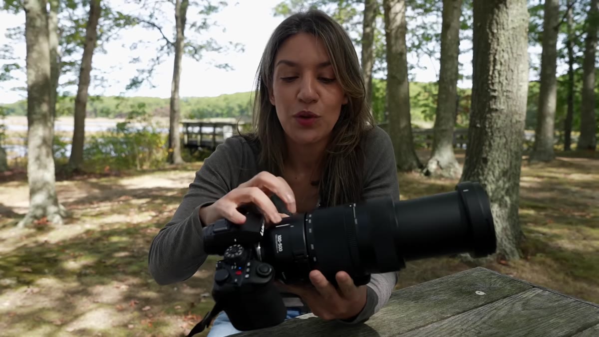 Tony holding the Lumix 100-500mm lens, demonstrating its heft