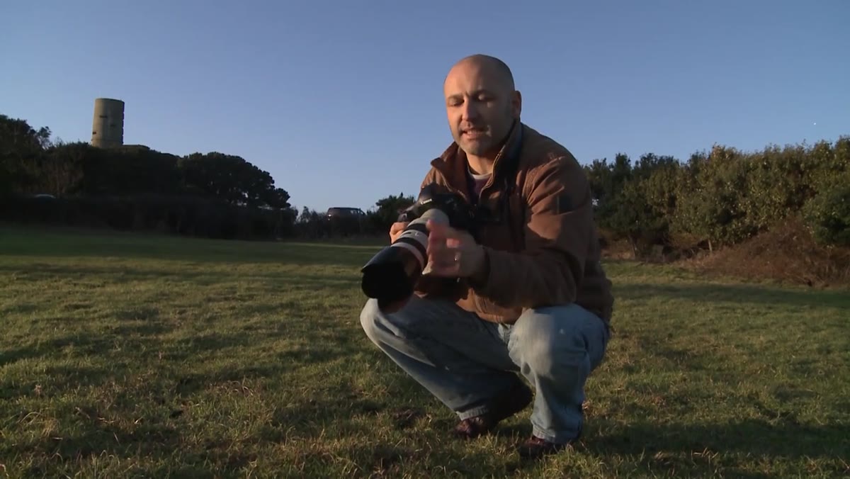 Lens hood shown extending beyond front element of lens