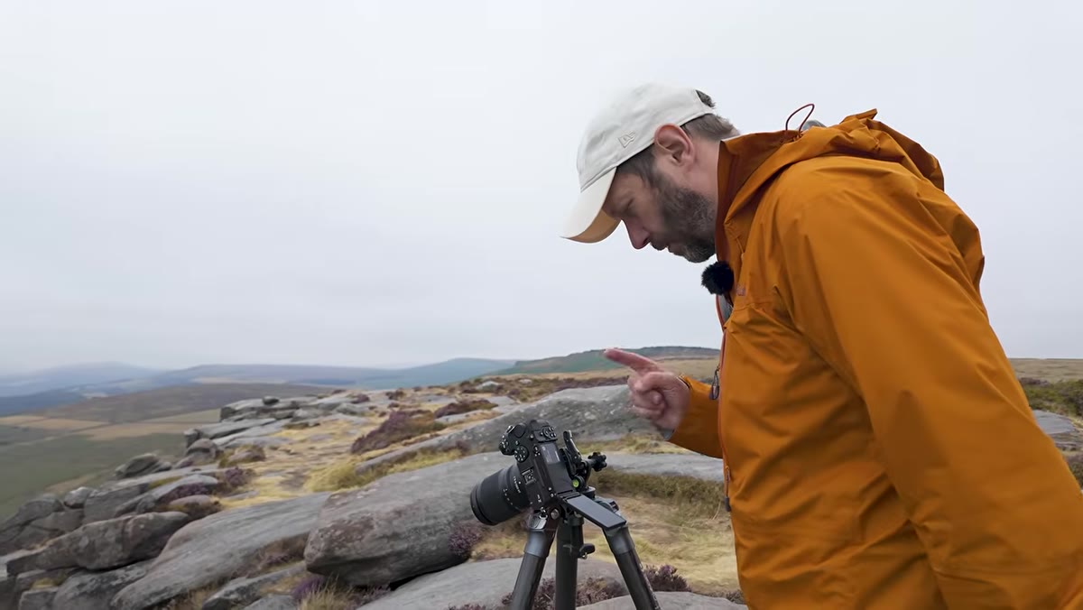Danson tapping focus points on screen across foreground and background