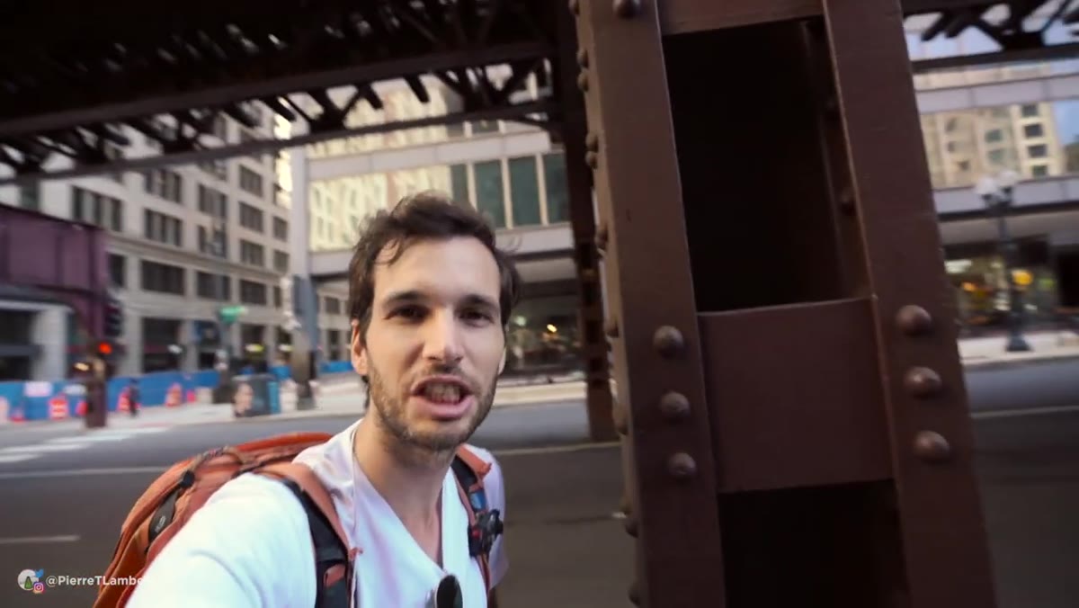 Pierre pointing to poles, trucks, and mirrors as natural framing elements in the scene