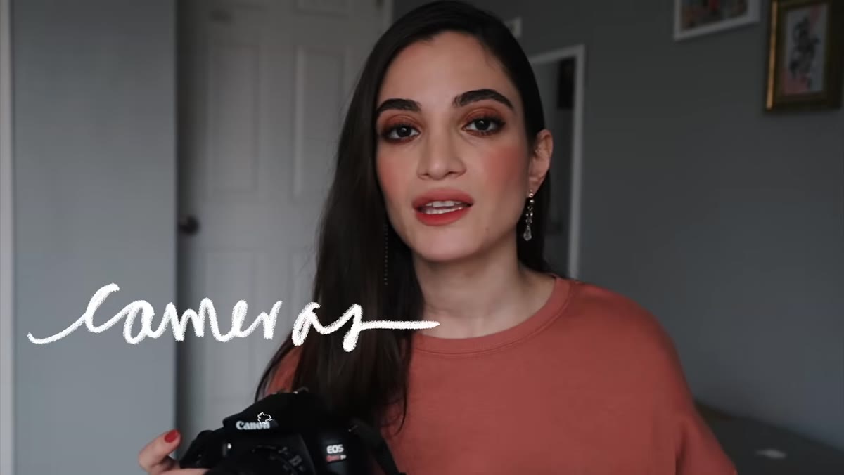 Jessica holding up a camera body with no lens attached