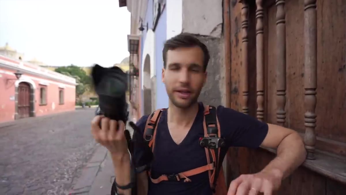 Lambert shooting in a narrow street, adjusting focal length between frames