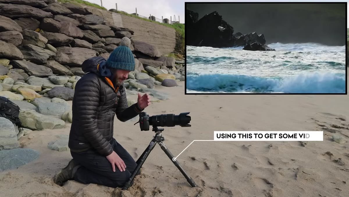 Danson positioned low on rocks tracking incoming waves