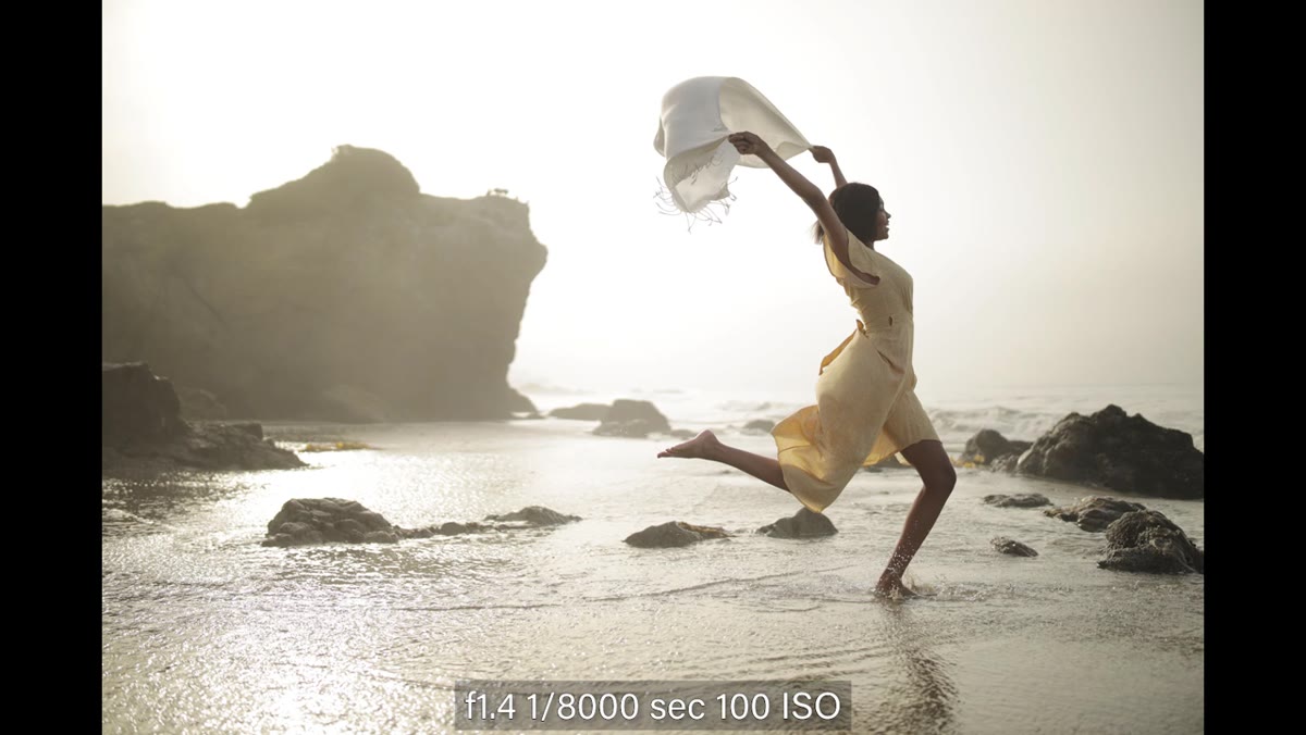 Model jumping mid-air with scarf frozen at 1/8000s