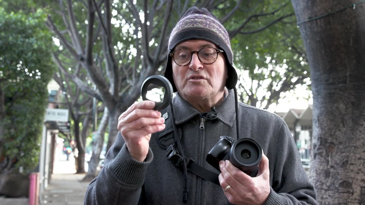 Cutout lens hood on the 35mm being attached to lens