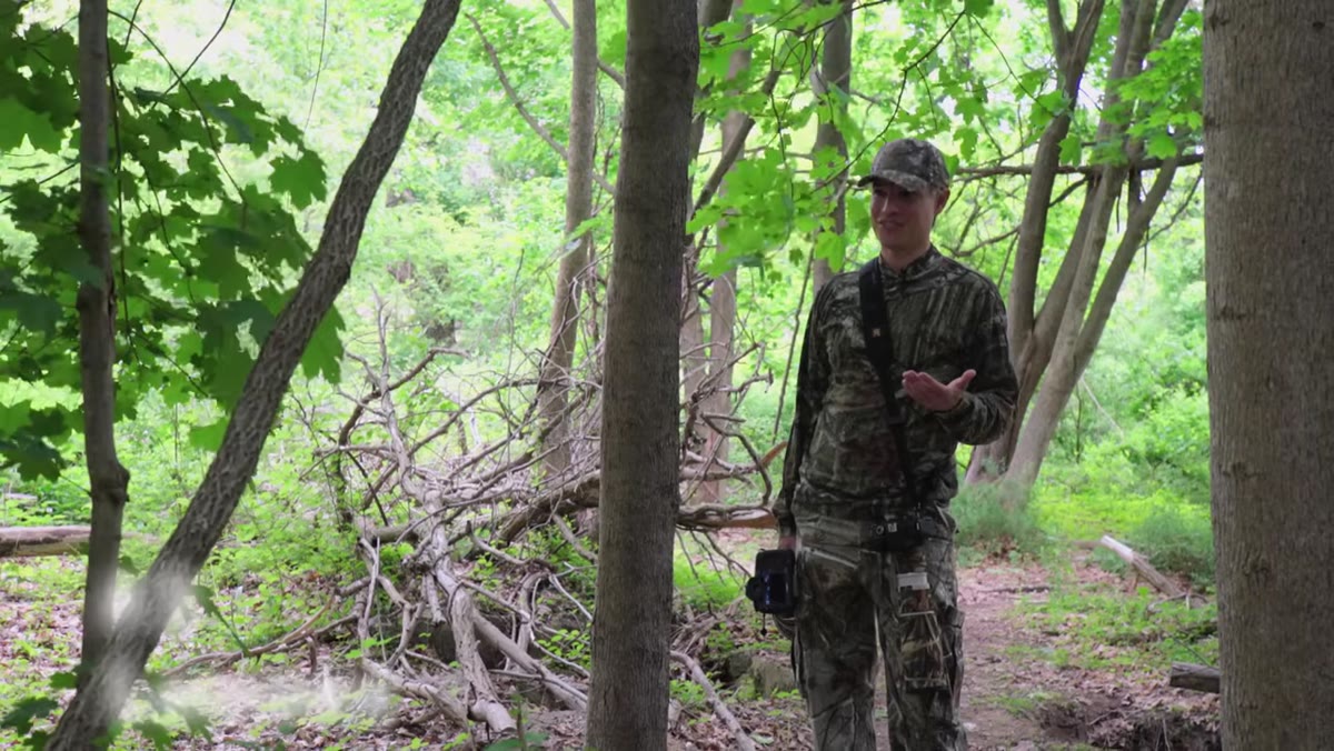 Tony holding a large telephoto prime lens in the field