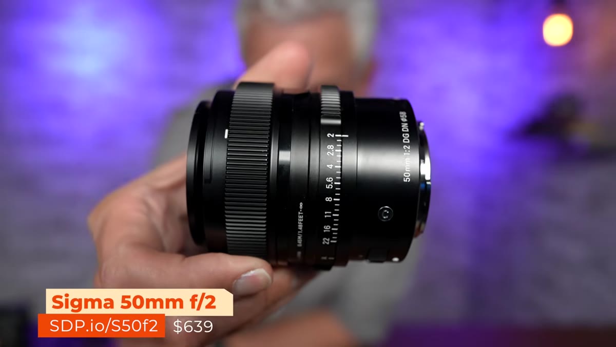Tony holding the Sigma 50mm f/2 lens up to camera