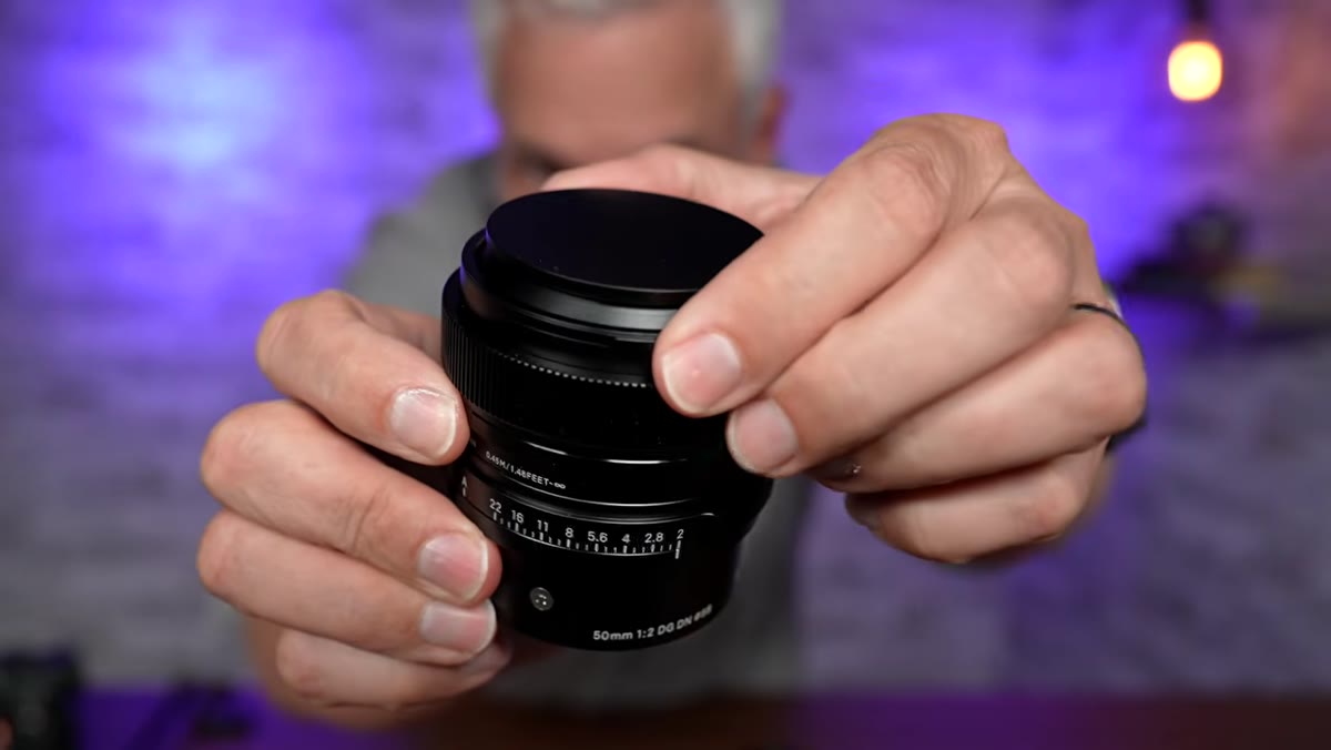 Close-up of the magnetic lens hood being attached and removed