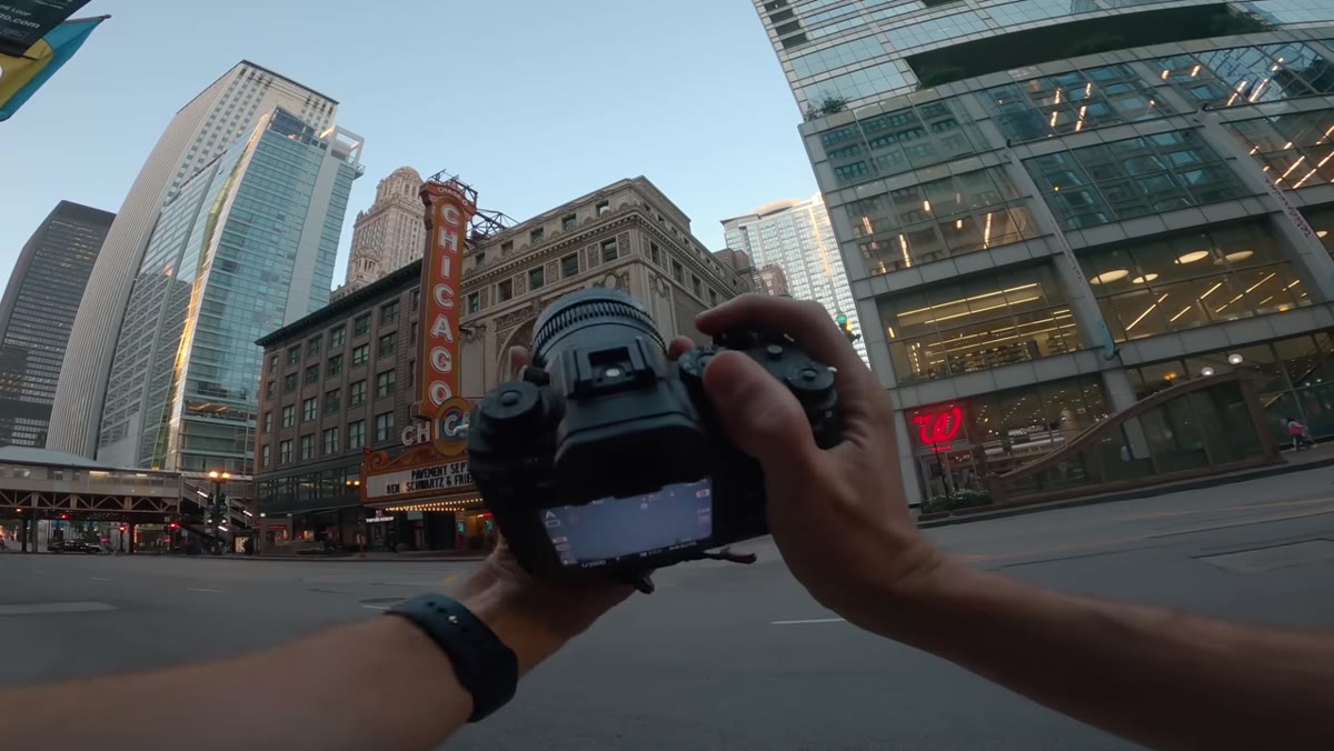 Photographer rotating lens mount to vertical orientation for portrait framing