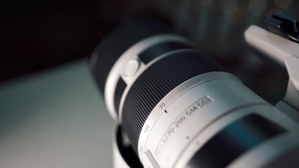 Pierre holding the 70-200mm lens, discussing its range