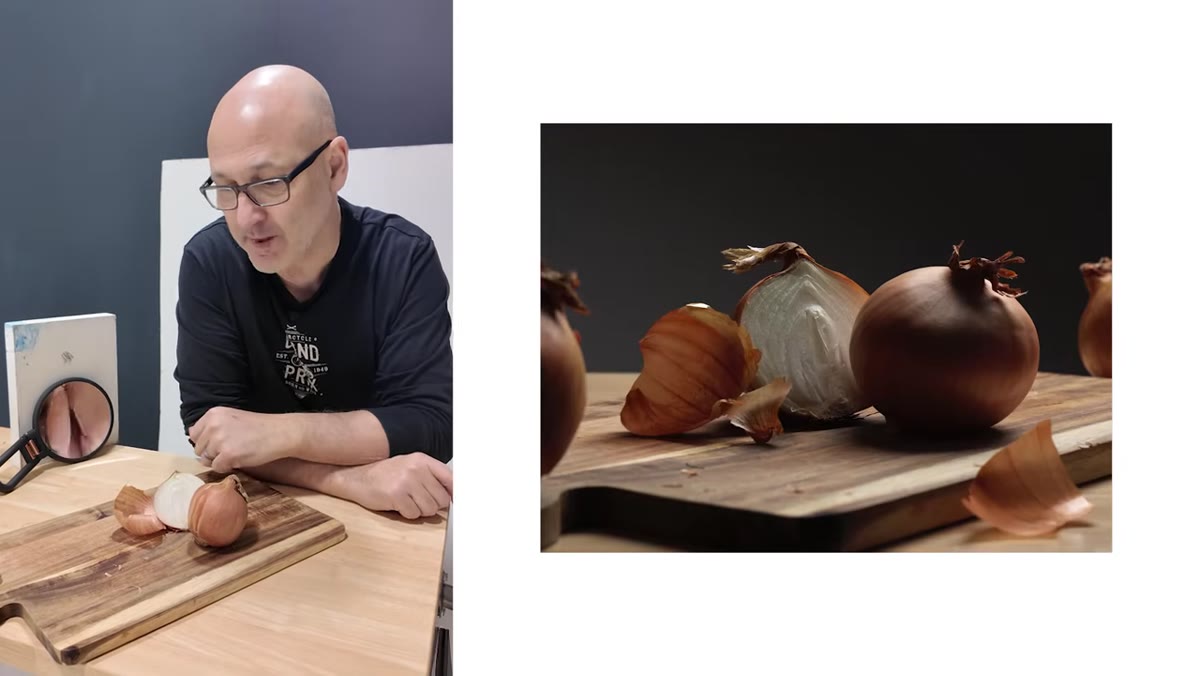 Two onions on a chopping board against a white wall