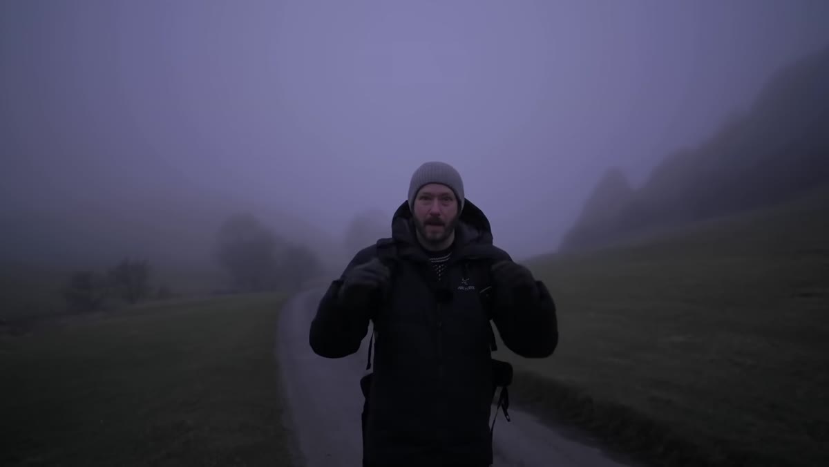 Mist covering hillside before sunrise with low visibility