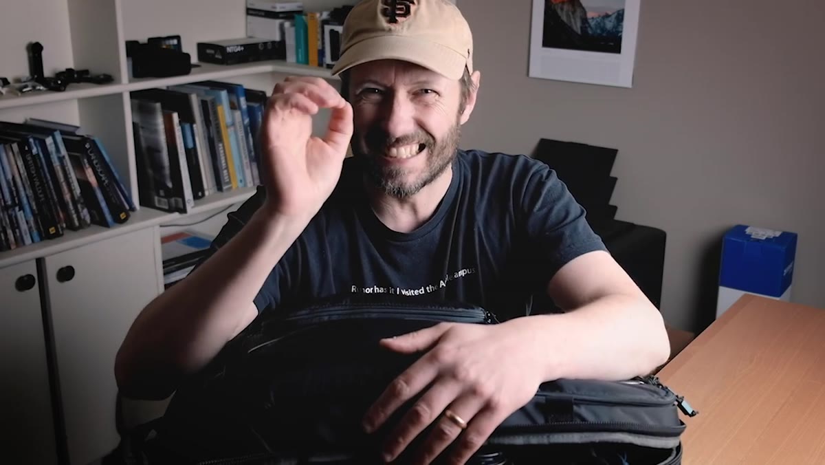 Nigel opening the Thule 32L backpack on a table