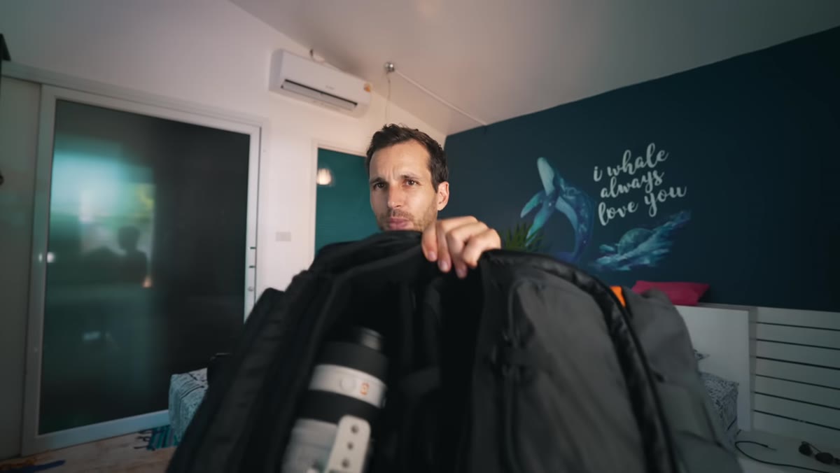 Pierre holding the 70-200 lens, showing how it dominates the bag