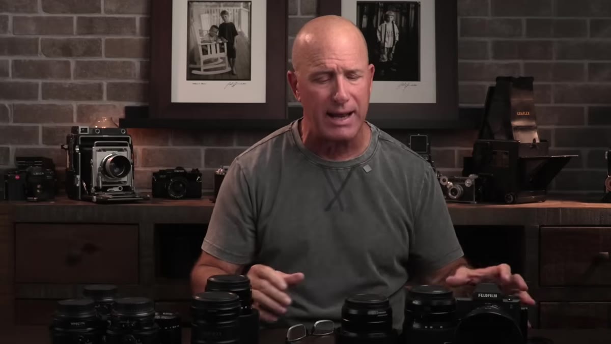 Joel holding the 80mm f/1.7 and explaining its field use