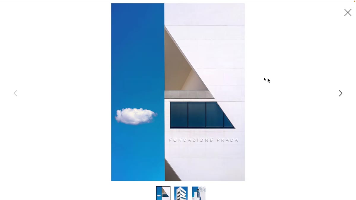 White building with strong shadows and cloud formations