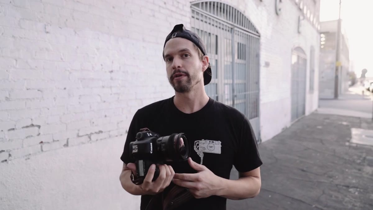 Photographer framing a close portrait with 24mm lens