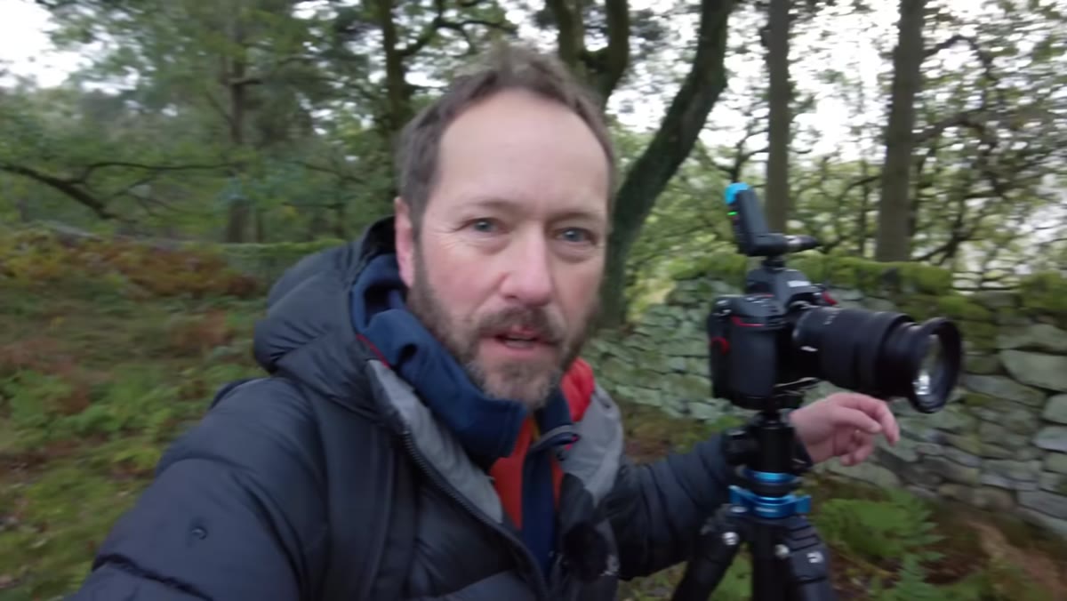 Danson holding the Nikon 24-120mm f/4 S lens up to camera